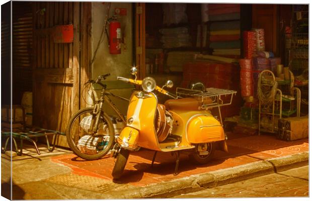 Yellow scooter Canvas Print by Kevin Hellon
