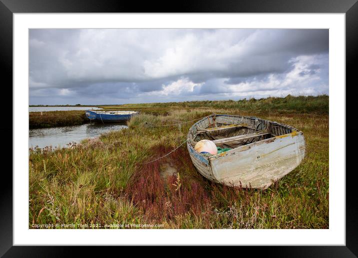 Old rowing boat on marsh grass Framed Mounted Print by Martin Tosh