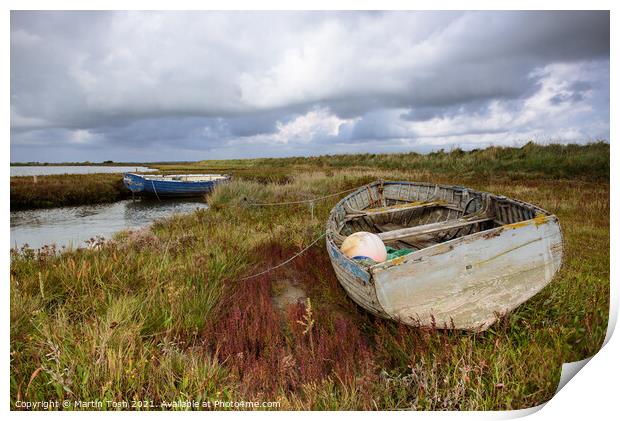 Old rowing boat on marsh grass Print by Martin Tosh