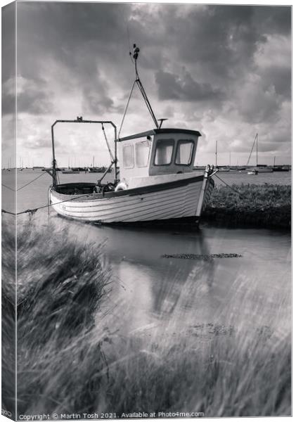 Fishing boat in salt marsh Canvas Print by Martin Tosh