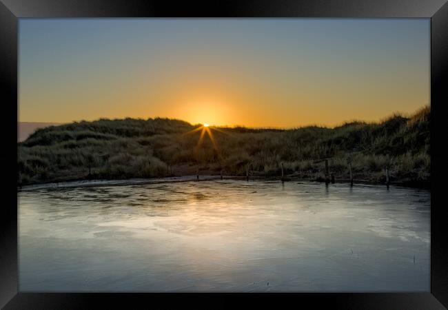 Frozen Pond in the Ainsdale Sand Dunes Framed Print by Roger Green