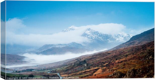 Snowdon emerges from the clouds. Canvas Print by John Henderson