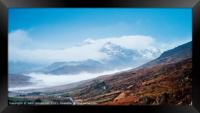 Snowdon emerges from the clouds. Framed Print by John Henderson