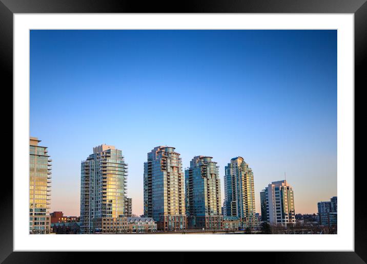Apartment buildings at sunset  Framed Mounted Print by eacmich 