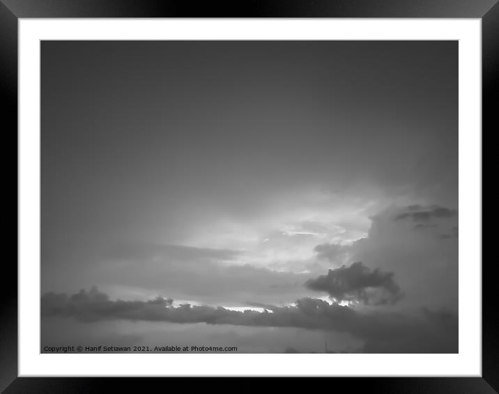 Grey white cloudscape with dark distinctive cloud shapes. Framed Mounted Print by Hanif Setiawan
