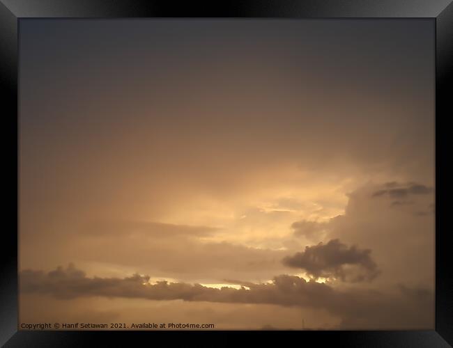 Brown golden cloudscape with cloud shapes. Framed Print by Hanif Setiawan
