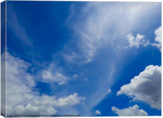 Fluffy white cloud shapes at blue sky. Canvas Print by Hanif Setiawan