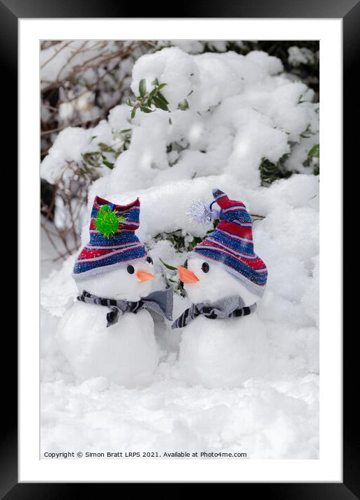 Two cute little snowmen dressed for snow Framed Mounted Print by Simon Bratt LRPS