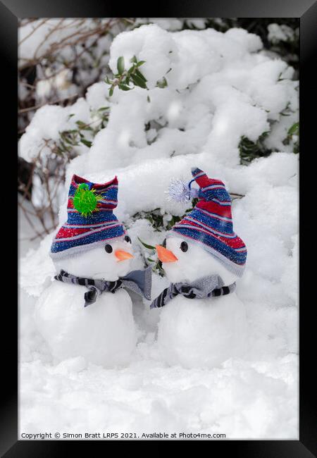 Two cute little snowmen dressed for snow Framed Print by Simon Bratt LRPS