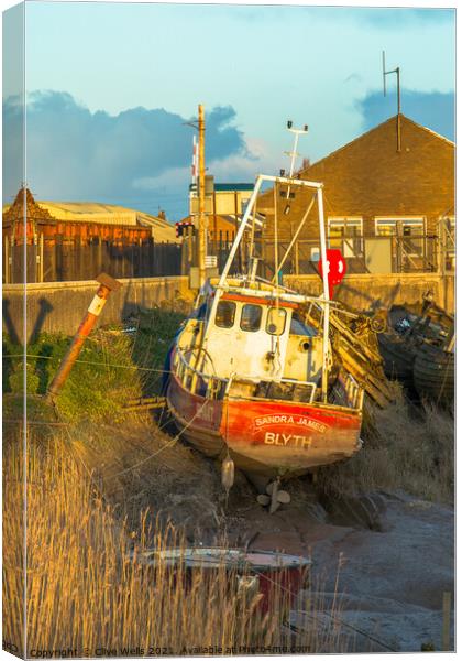 Small fishing boat stuck on the mud Canvas Print by Clive Wells