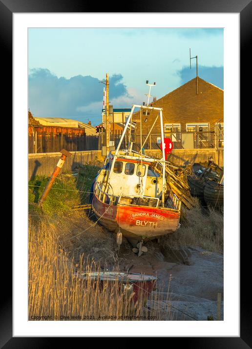 Small fishing boat stuck on the mud Framed Mounted Print by Clive Wells