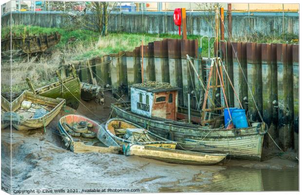 Abandoned boats at low tide Canvas Print by Clive Wells