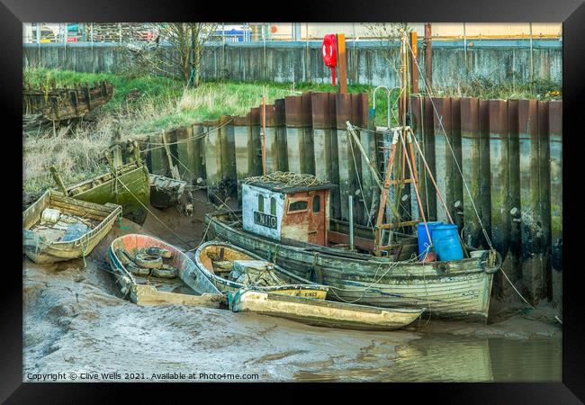 Abandoned boats at low tide Framed Print by Clive Wells