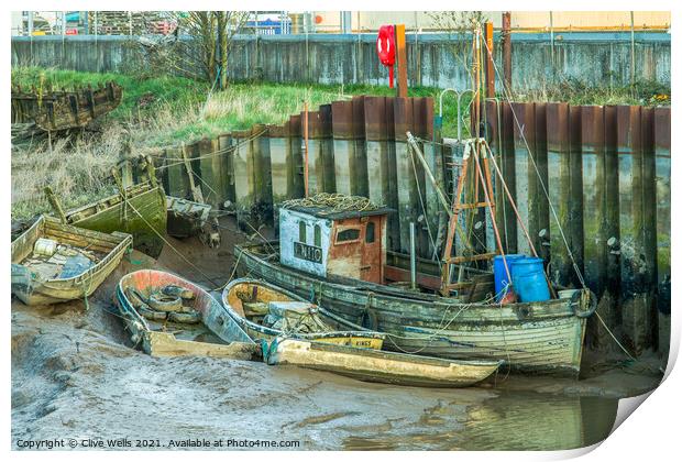 Abandoned boats at low tide Print by Clive Wells