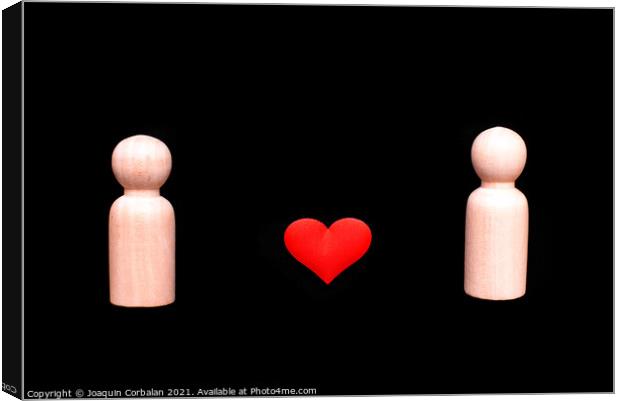 Wooden figures representing a homosexual couple of two gay men in love, with a beautiful red heart, isolated on a black background. Canvas Print by Joaquin Corbalan