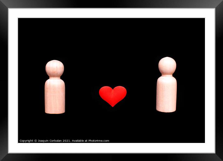 Wooden figures representing a homosexual couple of two gay men in love, with a beautiful red heart, isolated on a black background. Framed Mounted Print by Joaquin Corbalan