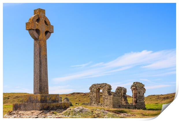 Celtic cross and the remains of St. Dwynwen church Print by Kevin Hellon