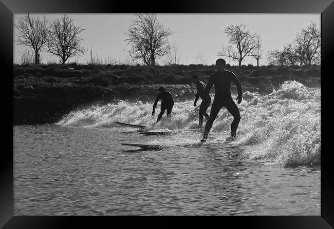 Surfers riding a wave on the river Severn Framed Print by mark humpage