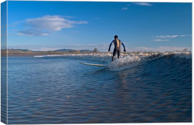 Lone surfer riding a wave on the river Severn Canvas Print by mark humpage