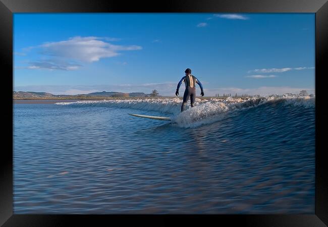 Lone surfer riding a wave on the river Severn Framed Print by mark humpage