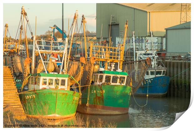 Fishing boats at low tide Print by Clive Wells