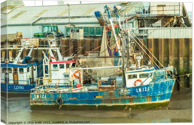 Grounded fishing boat Canvas Print by Clive Wells