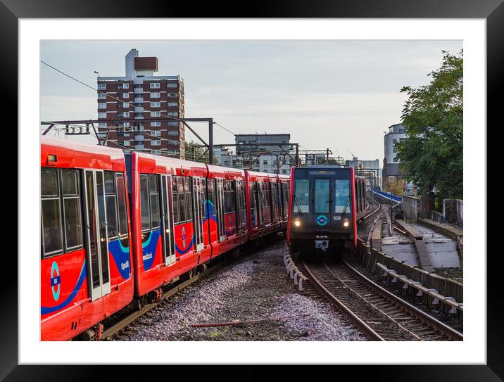 Trains passing on the DLR Framed Mounted Print by Jason Wells
