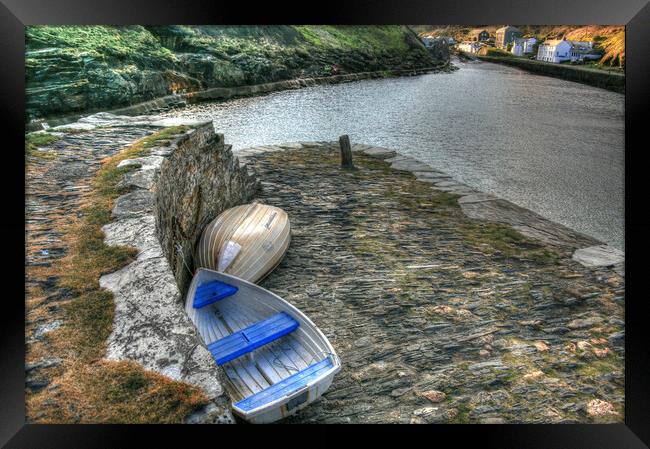 Dinghy's Parked on sea wall Framed Print by Dave Bell