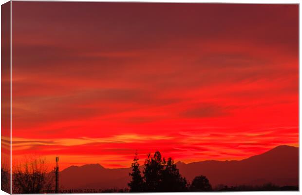 a spectacular sunset over the mountains paints the sky of red Canvas Print by susanna mattioda