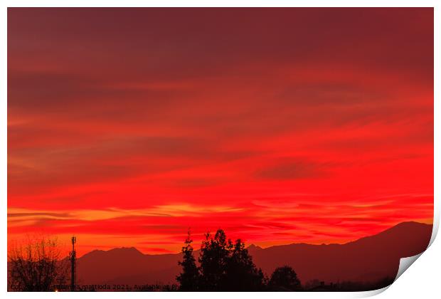 a spectacular sunset over the mountains paints the sky of red Print by susanna mattioda
