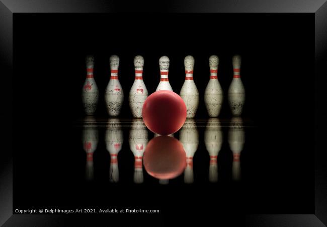 Strike, bowling ball and pins aligned on black  Framed Print by Delphimages Art
