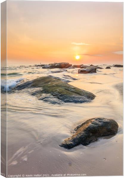 Sunrise over the rocks Canvas Print by Kevin Hellon