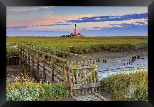 Footbridge and Lighthouse Westerheversand at Eiderstedt, Germany Framed Print by Arterra 