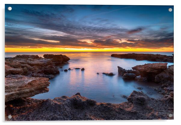 Beautiful sunrise over rocks at the beach at Torre de la Sal Acrylic by Helen Hotson