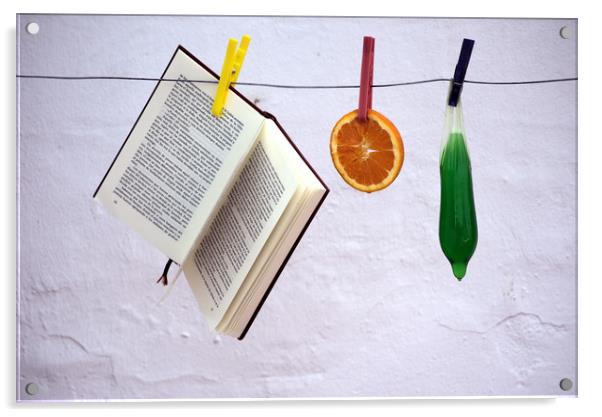 This is a still lfe made with an orange, a book an Acrylic by Jose Manuel Espigares Garc