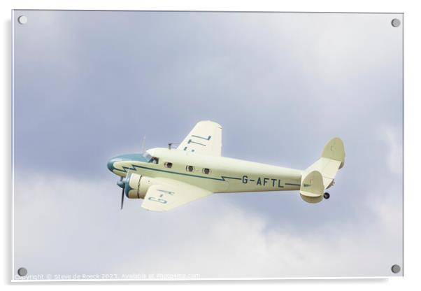 Lockheed Electra in a cloudy sky Acrylic by Steve de Roeck