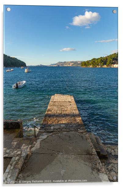 Stone pier in the sea with mountains in the background Acrylic by Sergey Fedoskin