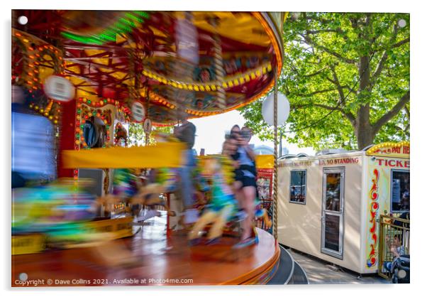 Fairground carousel ride blurred to show speed and movement with small child watching, London UK Acrylic by Dave Collins