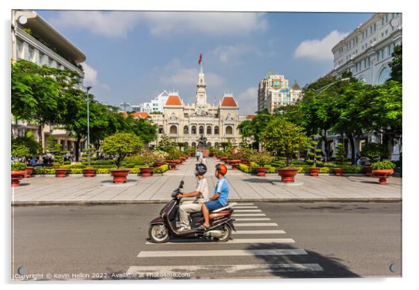 A motorcyclist rides along the road.past a statue of Ho Chi Minh Acrylic by Kevin Hellon
