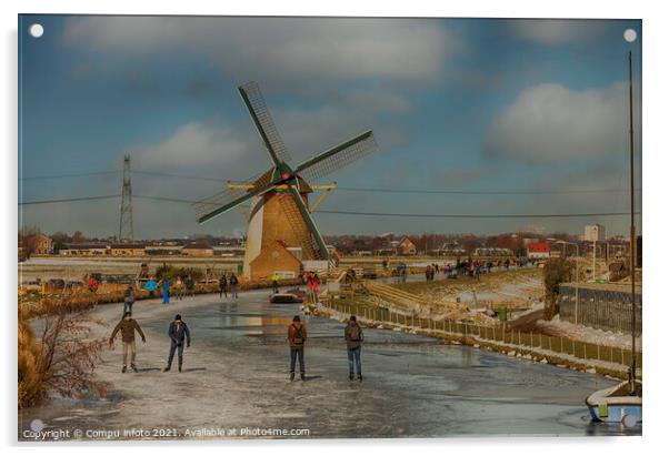 People skating om ice with windmill as background Acrylic by Chris Willemsen