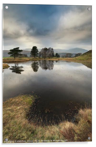 Stunning landscape image of dramatic storm clouds over Kelly Hall Tarn in Lake District during late Autumn Fall afternoon Acrylic by Matthew Gibson