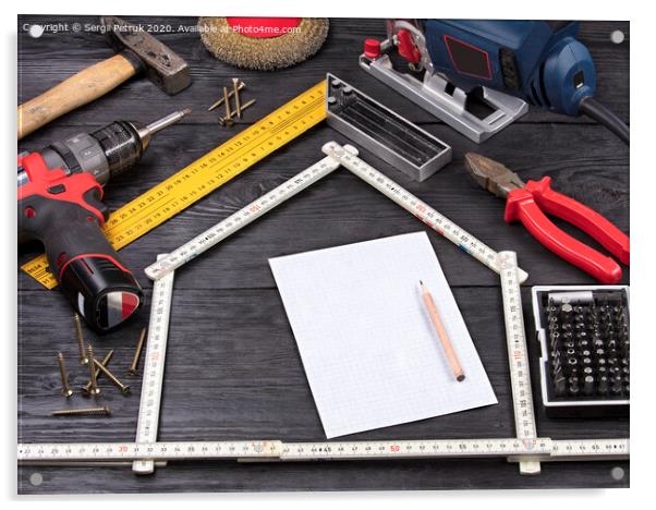 Tool for construction and repair on a black wooden background around a white sheet of paper with a pencil Acrylic by Sergii Petruk