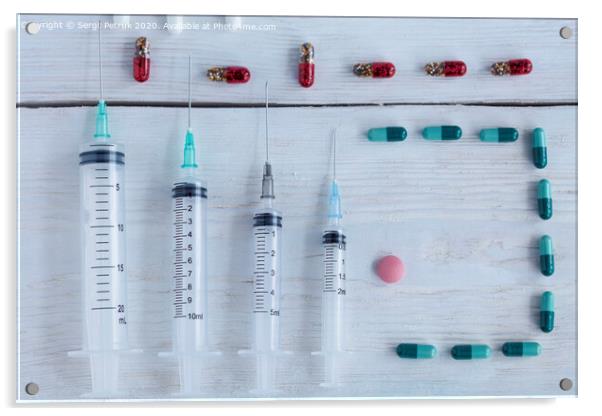 Medical syringes, capsules, pills lie vertically on a white roughly painted wooden table. Acrylic by Sergii Petruk