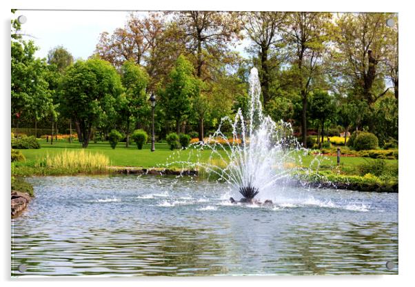 Beautiful fountain in the midst of a spring pond against the backdrop of a picturesque city park Acrylic by Sergii Petruk