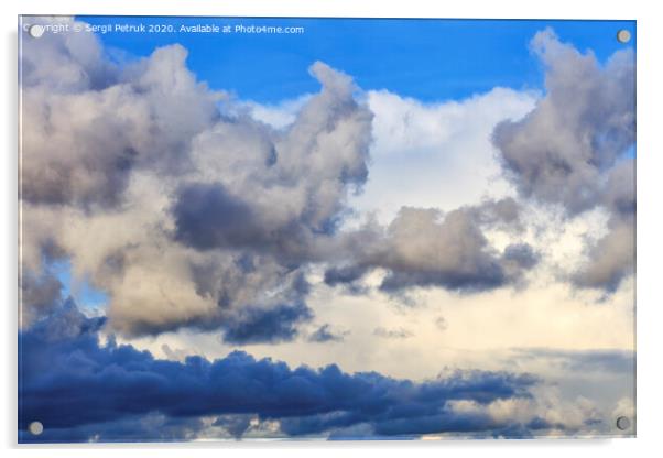 Storm clouds gather in a pile closing off a blue sky Acrylic by Sergii Petruk