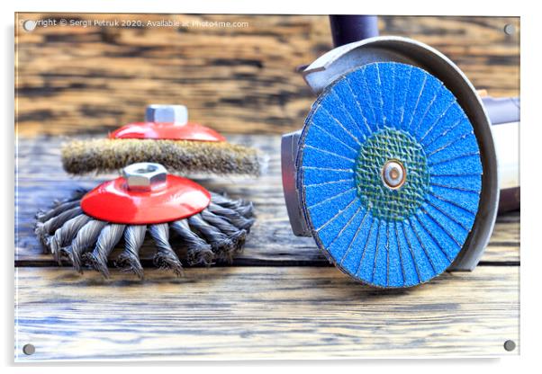 Angle grinder with grinding disc brushes lies on the background of a wooden table. Acrylic by Sergii Petruk