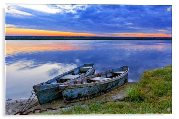 Two old blue-green boats moored by a metal chain to the shore of a calm river against the backdrop of the bright rising sun. Acrylic by Sergii Petruk