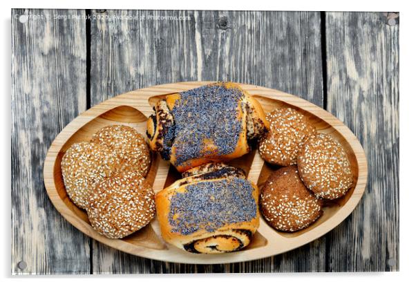 Homemade rolls with poppy seeds and oatmeal cookies with sesame seeds on a wooden tray, top view. Acrylic by Sergii Petruk
