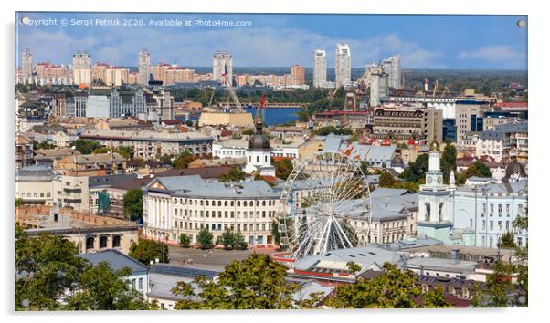 The landscape of the summer city of Kyiv overlooking the old district of Podil with a Ferris wheel and a bell tower with a gilded dome, the Dnipro River and many city buildings. Acrylic by Sergii Petruk