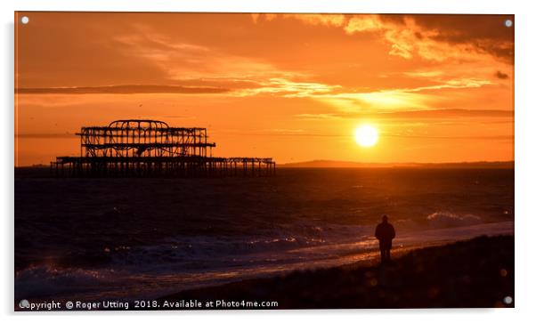 West pier sunset watcher Acrylic by Roger Utting